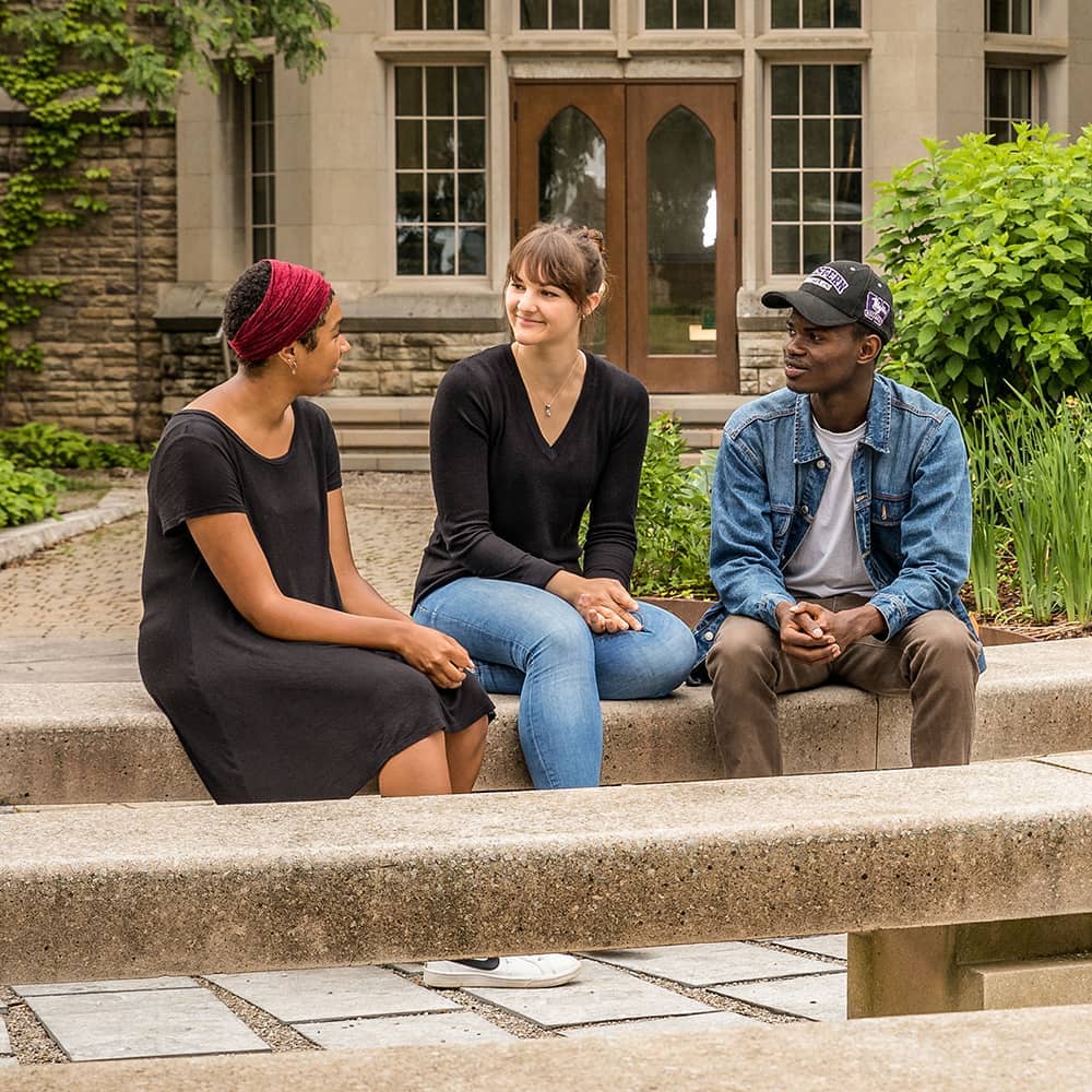 A group of students sitting in the Beryl Ivey garden